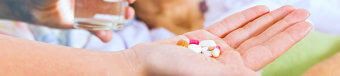 a picture of hand holding medicines